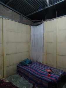 Photo depicting bedroom with gap between interior wall and roof.