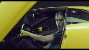 Bilderbuch lead singer in a yellow sportscar