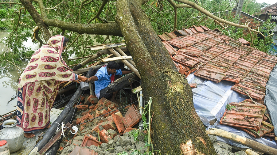 Villagers salvage items from their house damaged by Cyclone Amphan in West Bengal. Original Caption courtesy Al Jazeera. 