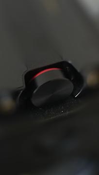 Black round volume knob with red ring