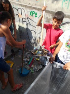 Clean up Day. During several occasions children cleaned the trash in the alley. 
